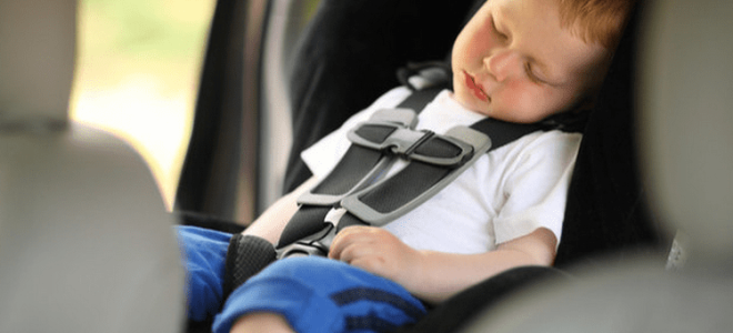 Where should a child sit in the car?